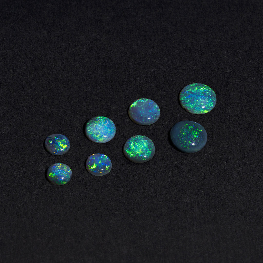 4 to 8mm Lightning Ridge Black Opal Round Cabs – Green Play of Color