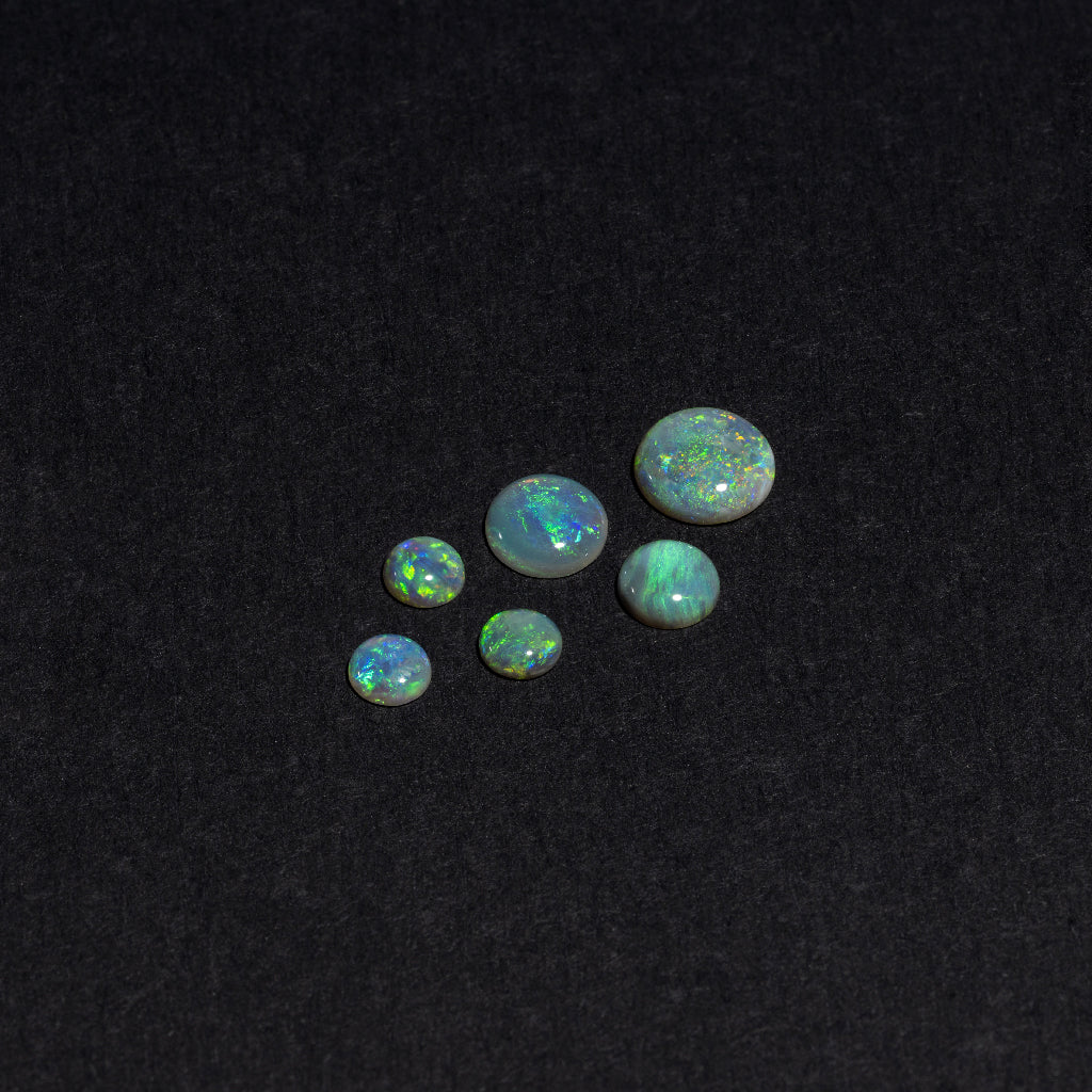 4 to 8mm Lightning Ridge Semi-Black Opal Round Cabs – Green Play of Color