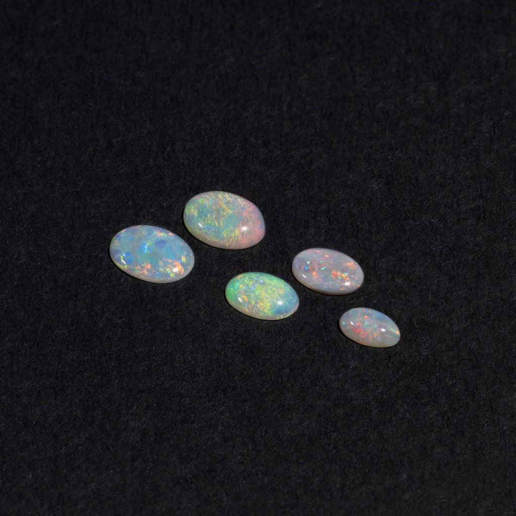 5x3 to 9x7mm Lightning Ridge White Opal Ovals – Orange Play of Color